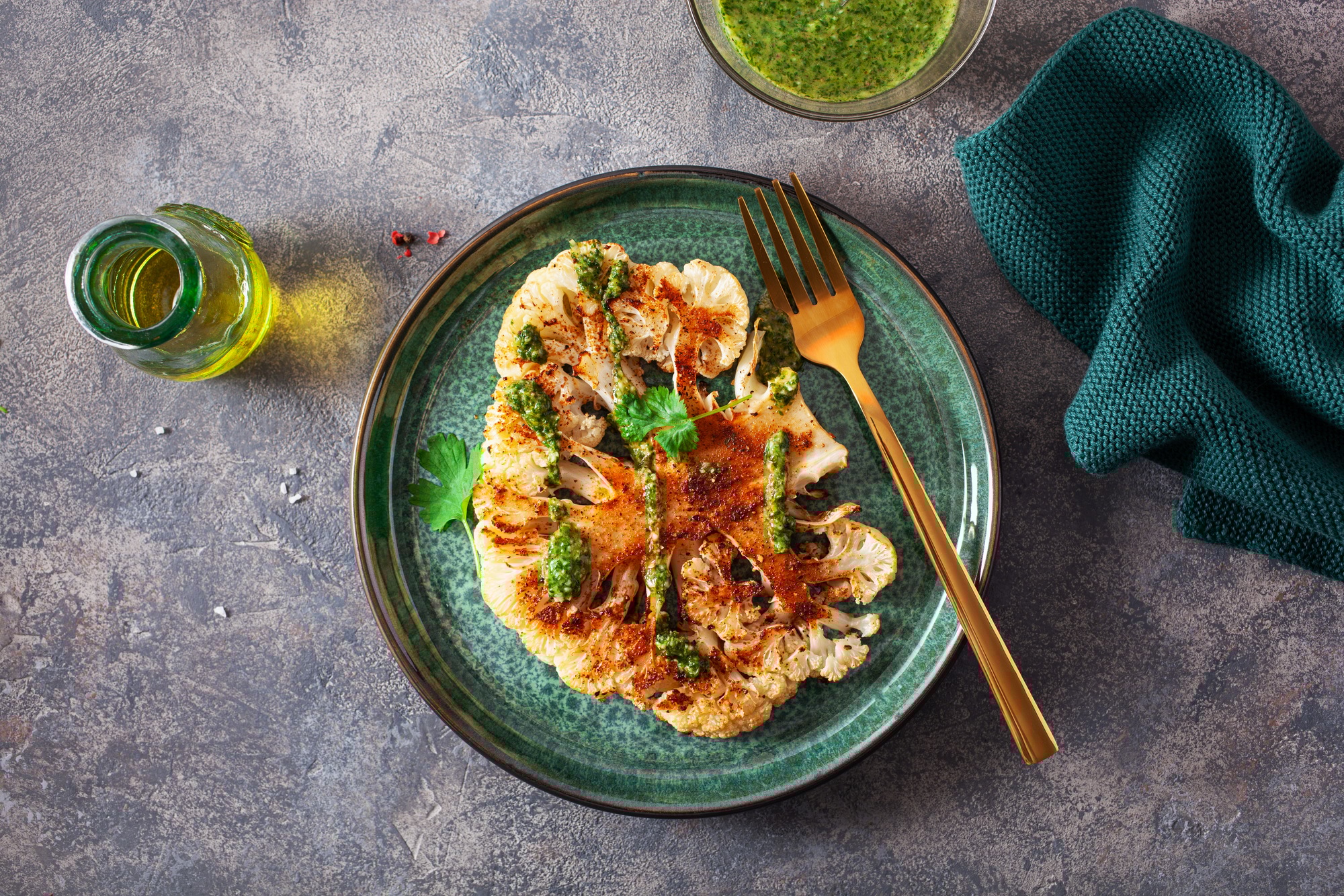 cauliflower steaks with herb sauce and spice. plant based meat substitute