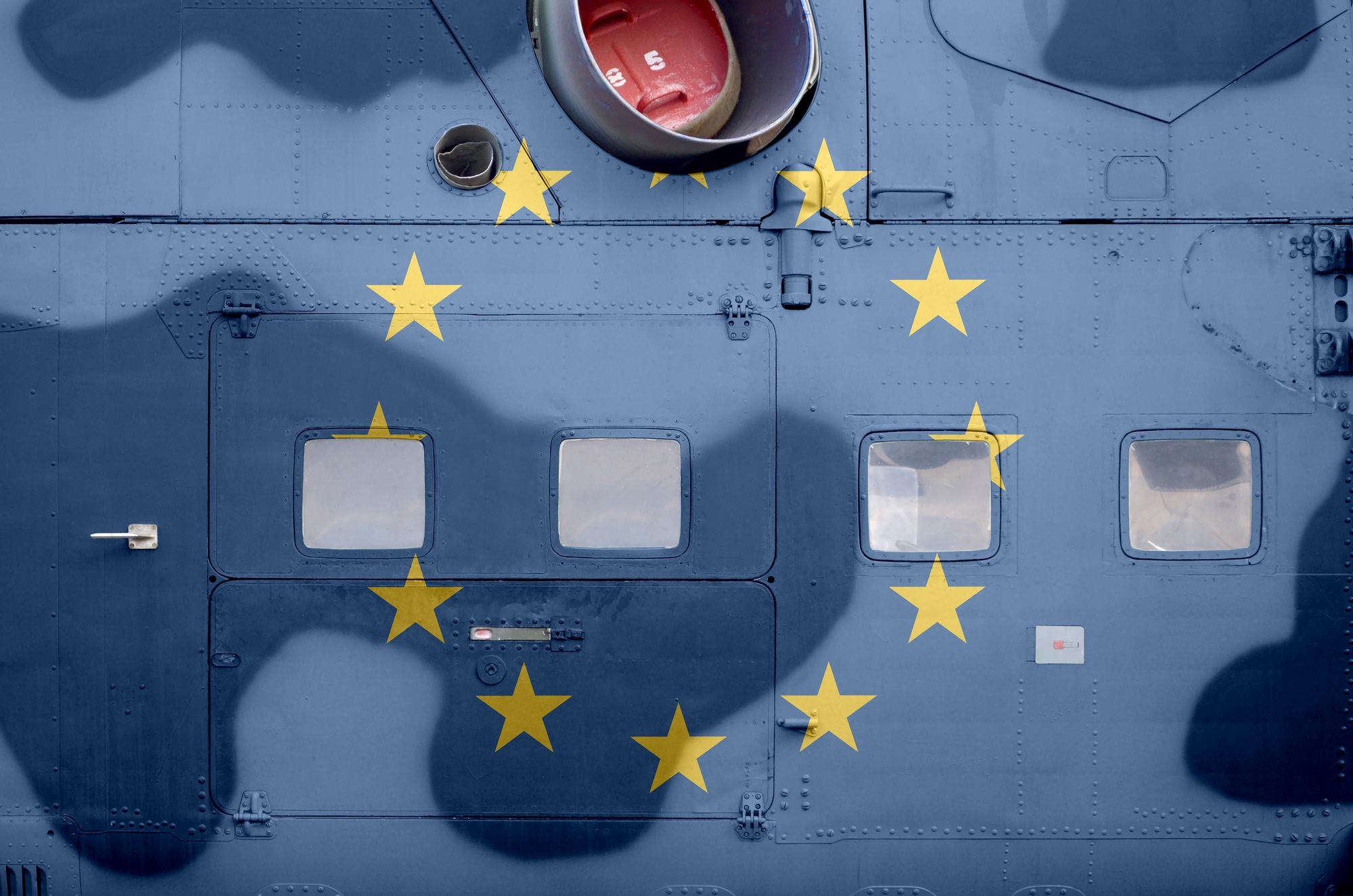 European union flag depicted on side part of military armored helicopter close up