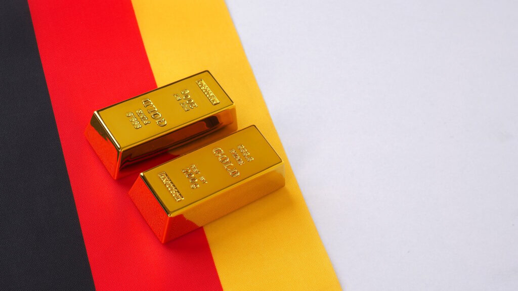 Gold bars and german flag on white background