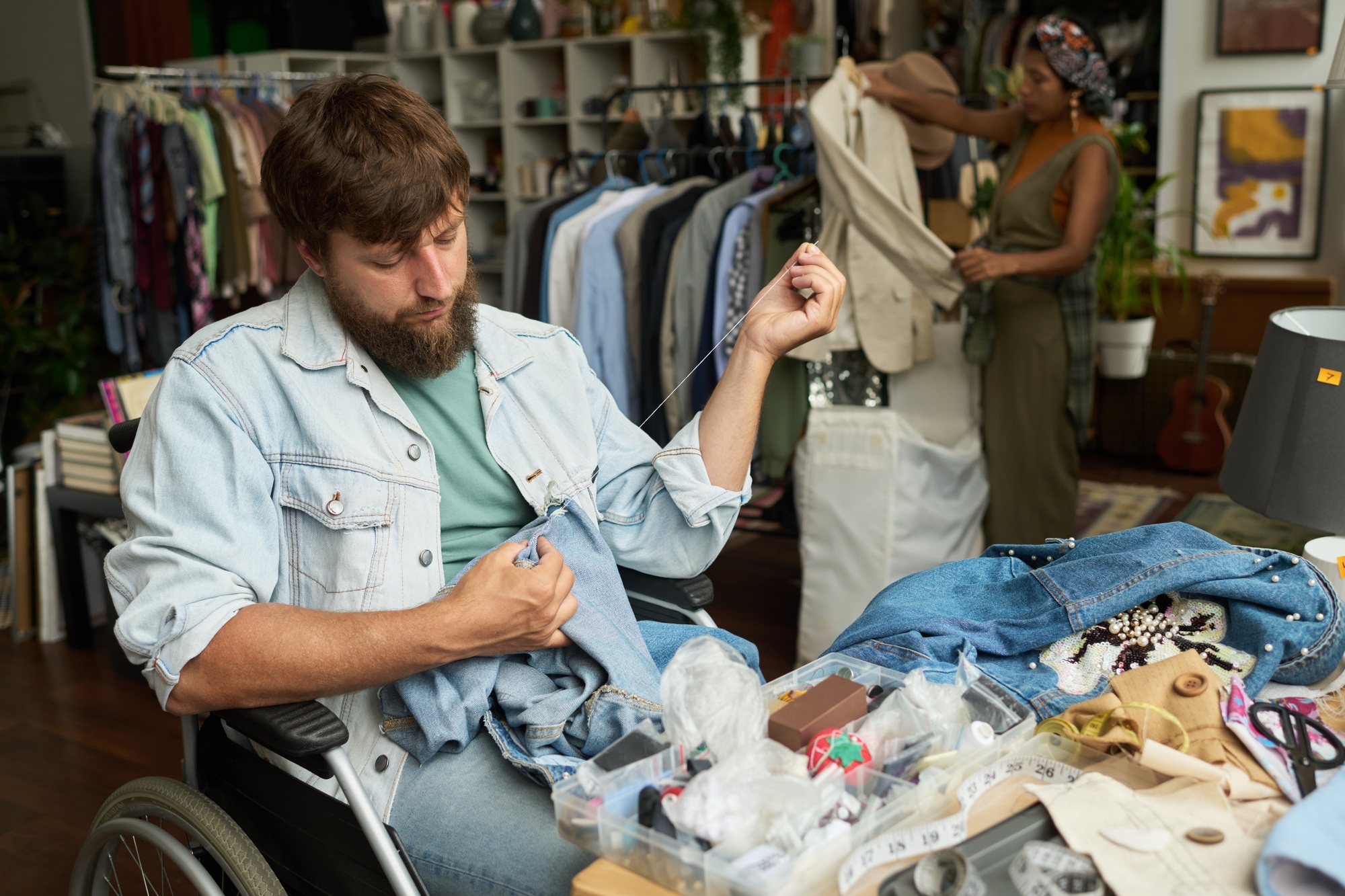 Man upcycling secondhand blue jeans