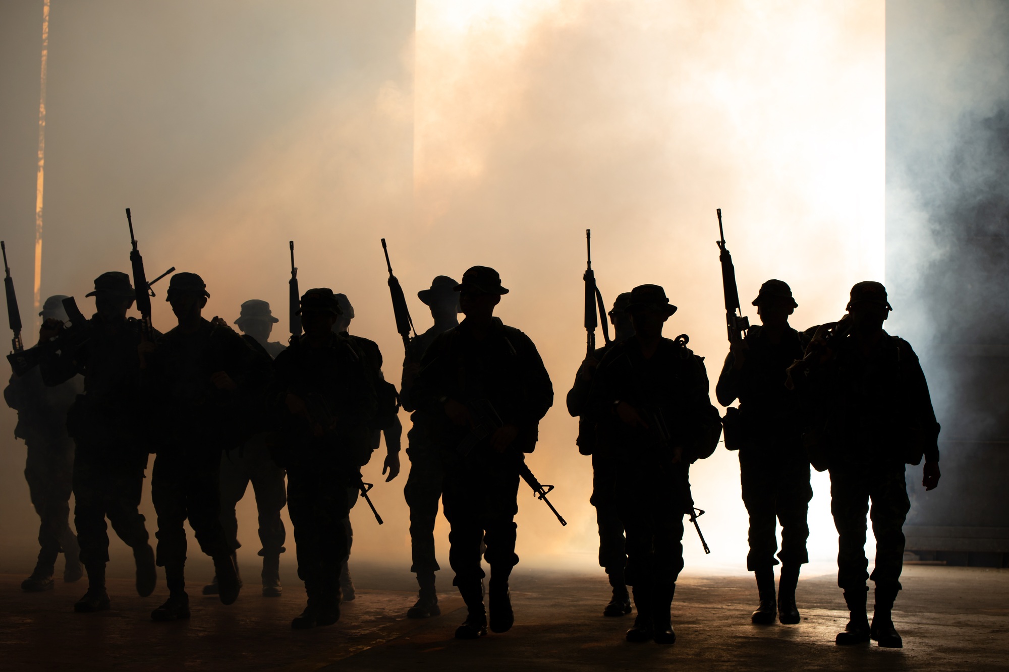 Silhouettes of soldiers during Military Mission at dusk