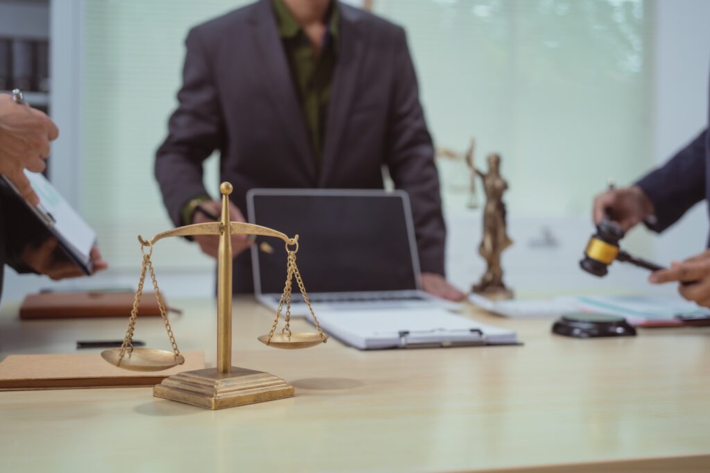 Three lawyers in a meeting at the table in an office, discussing business,civil and commercial law